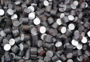 Metallic cylindrical pellets in a scattered pile.