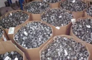 Boxes filled with metal pipe fittings.